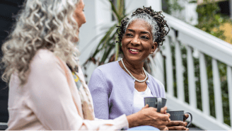 Two elderly woman enjoying coffee together