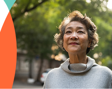 Elderly woman smiling happily outdoors